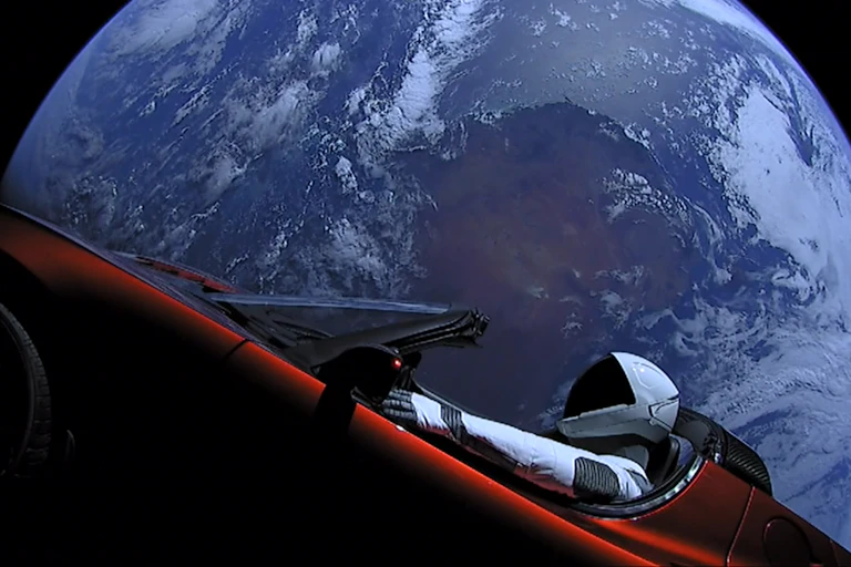 Elon Musk's Tesla Roadster, with Earth in background.