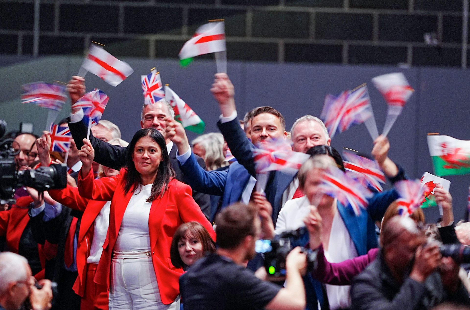 Government ministers waving flags.