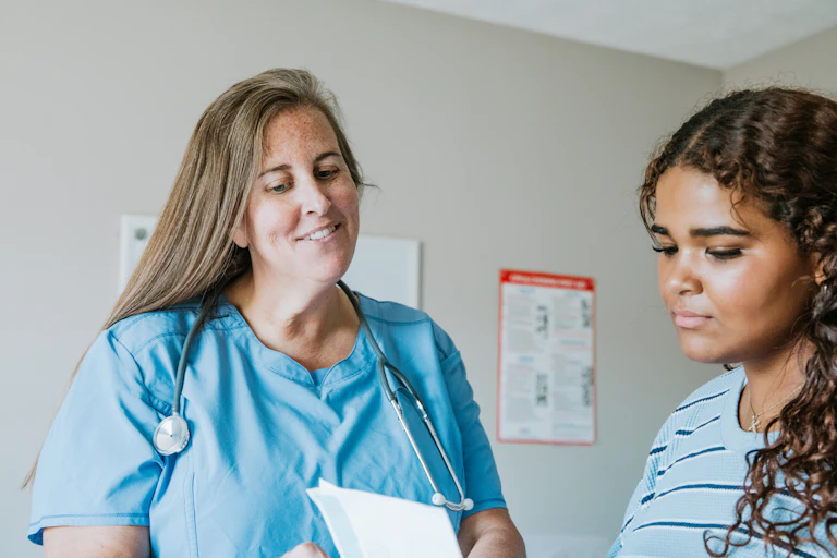 Nurse passes a prescription to her patient