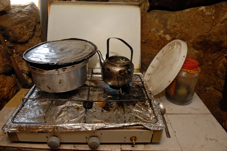 A cooking pot and a kettle on a stove in a Palestinian home on the West Bank near Hebron.