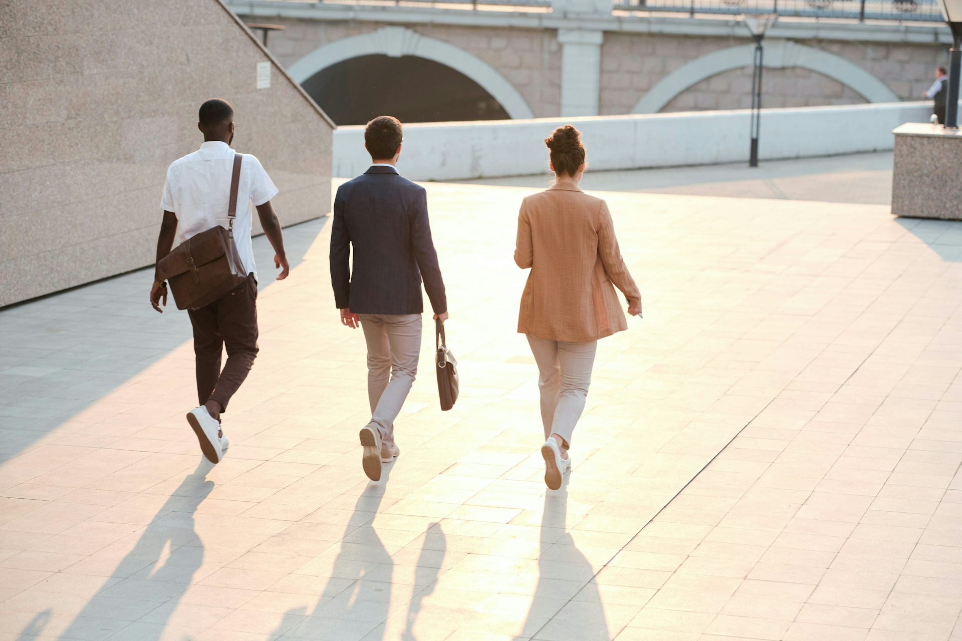 Three people in business clothes walking outdoors