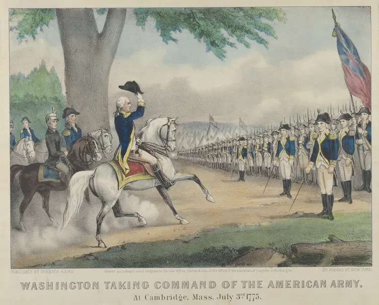 A man on a white horse and in a uniform saluting a long line of soldiers in front of him.