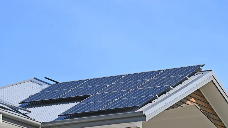 solar panel on rooftop against blue sky.
