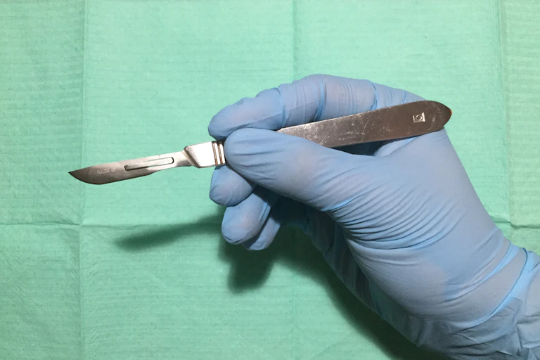 Gloves holding a scalpel