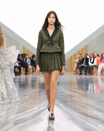Una mujer con un traje chaqueta con minifalda.