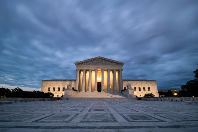 The Supreme Court building appears amid overcast skies.