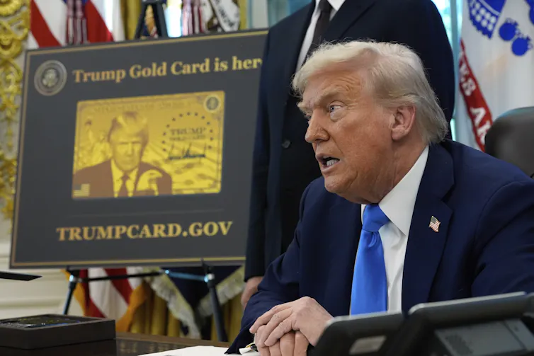 President Donal Trump appears seated in the oval office.
