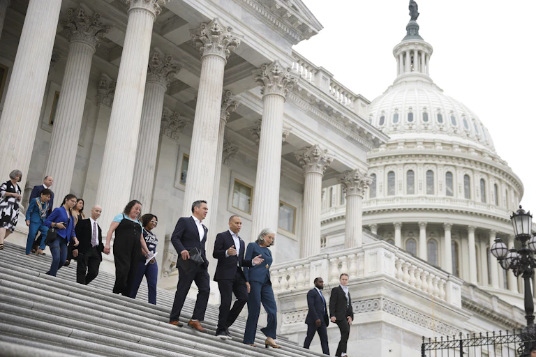 House Democrats walk down the steps of the U.S. Capitol Building