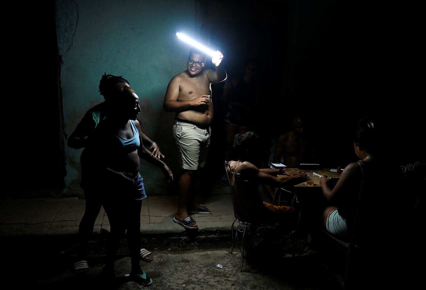 A man holds a light as others gather