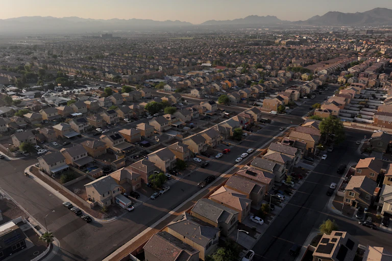 An aerial view of many houses lined in rows.