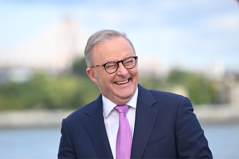 Anthony Albanese smiles and laughs
