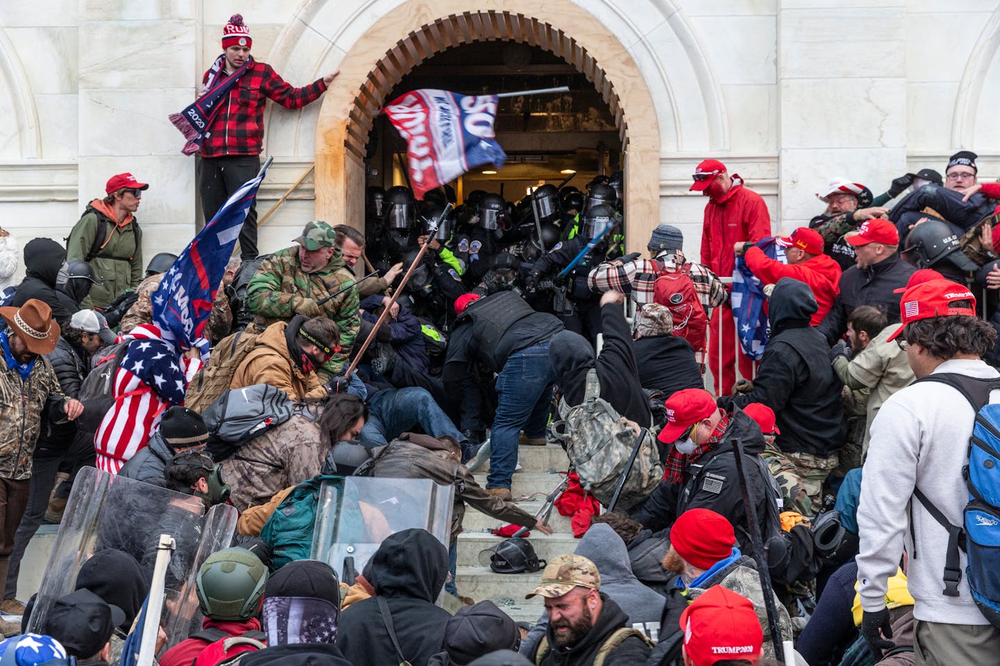 Rioters clash with police trying to enter Capitol building.