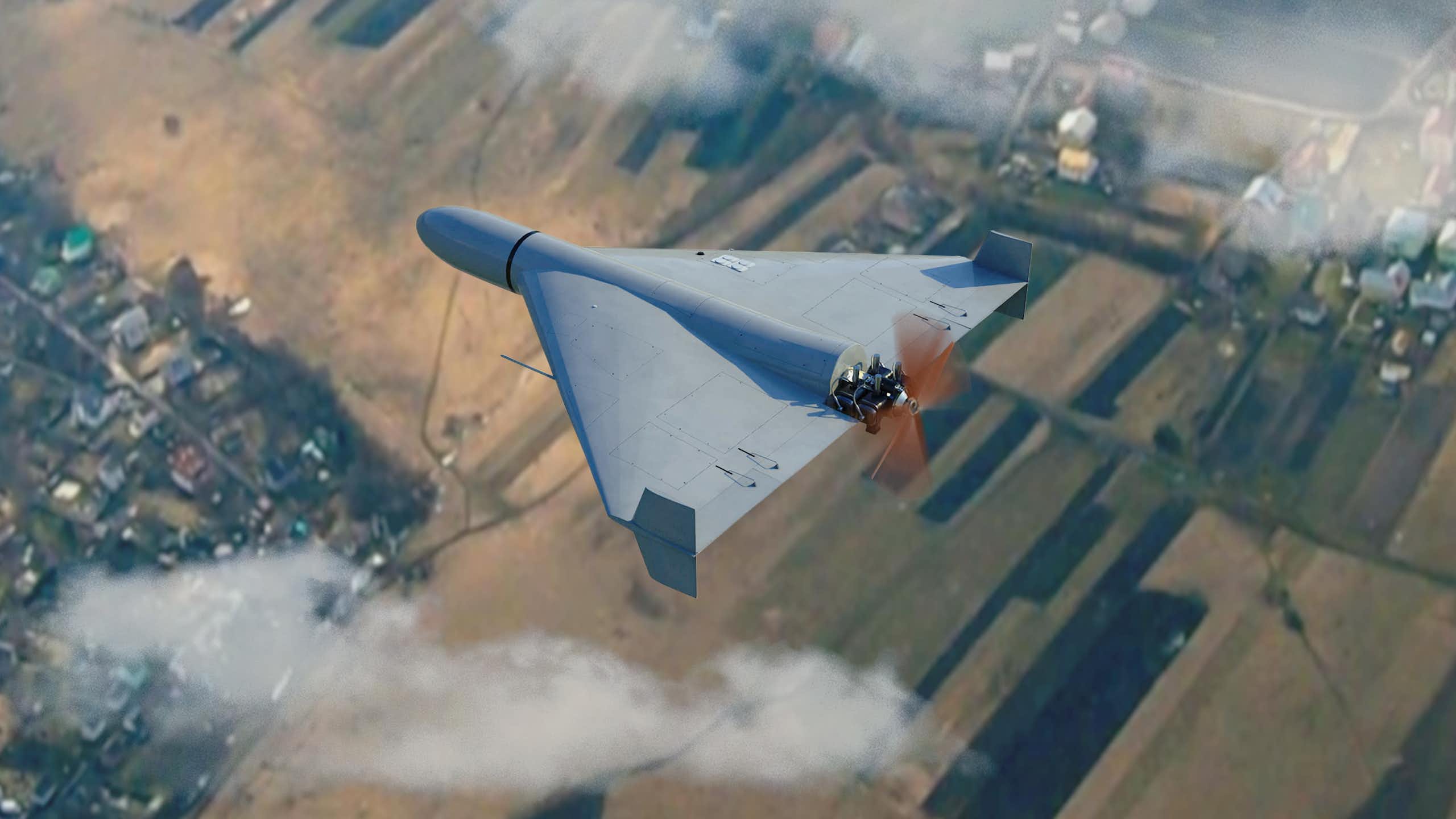 Military drone flying in the clouds above the countryside