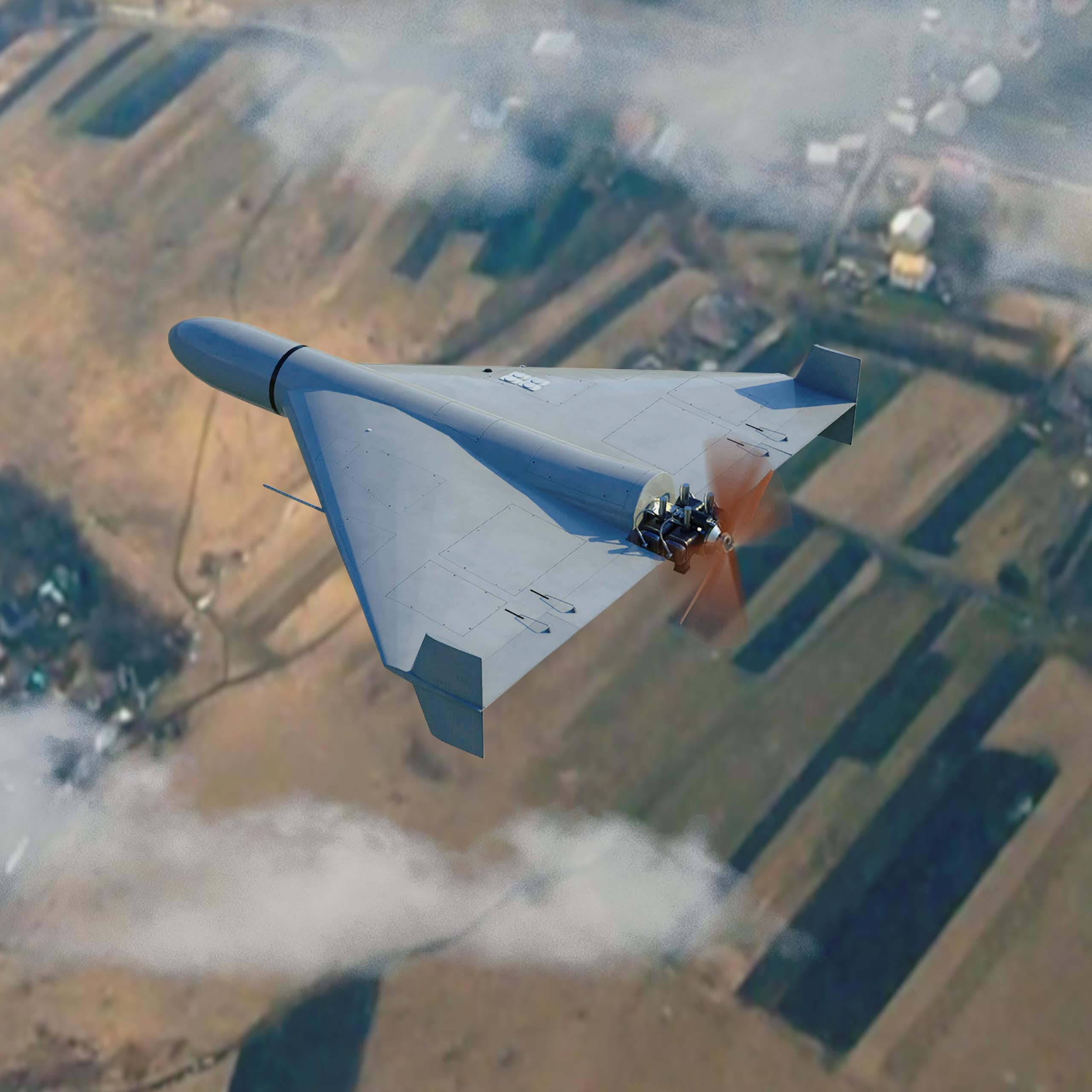 Military drone flying in the clouds above the countryside