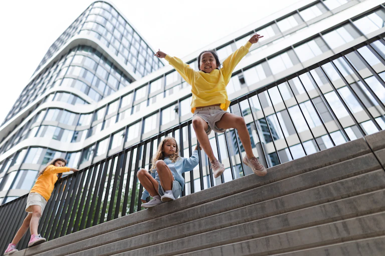 Girls jumping from wall in city