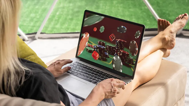 Close up cropped photo of girl hands on laptop featuring online gambling