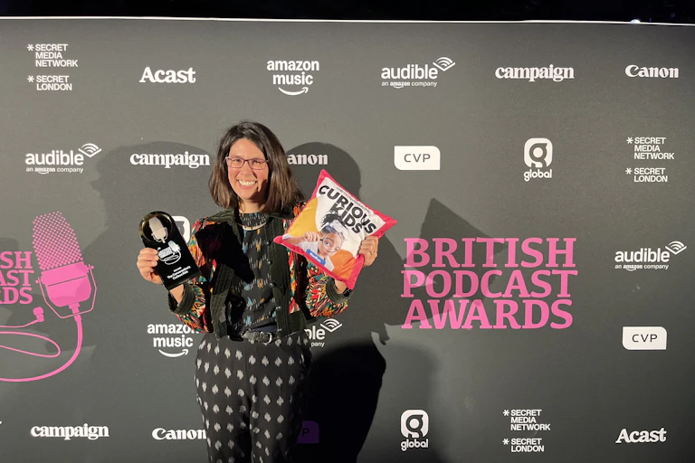 Eloise Stevens and British Podcast Award trophy.