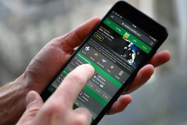 A person is seeing using a betting app on their phone.