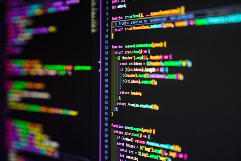 Lines of colourful computer code on a black screen.
