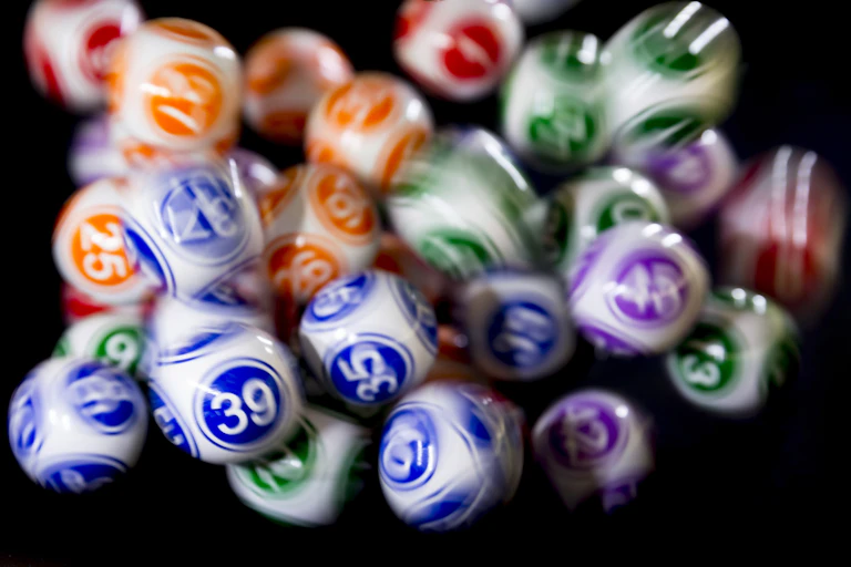 Lottery balls in motion, depicted by some being blurrier than others.
