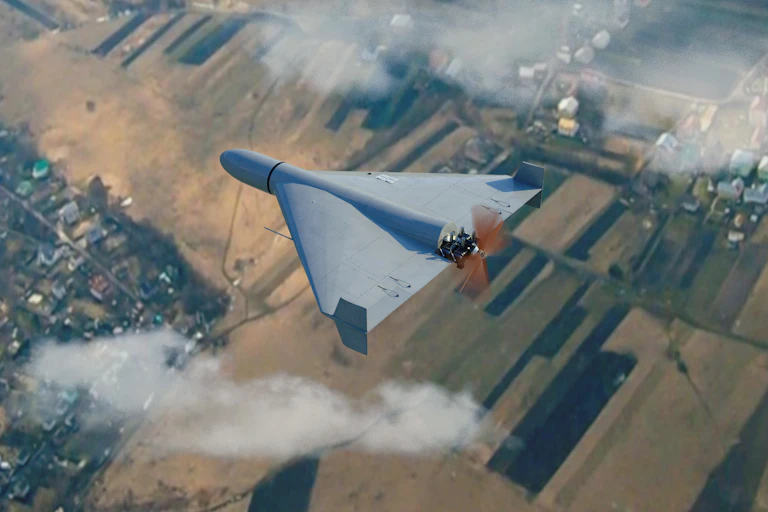 Military drone flying in the clouds above the countryside