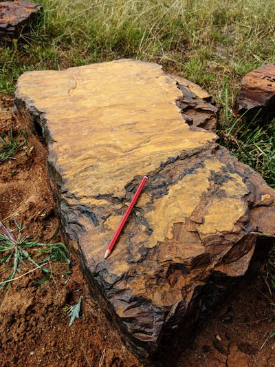 Large rectangular block of red rock composed of goethite, an iron-rich mineral.