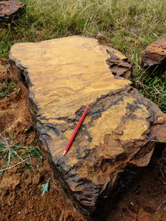 Large rectangular block of red rock composed of goethite, an iron-rich mineral.