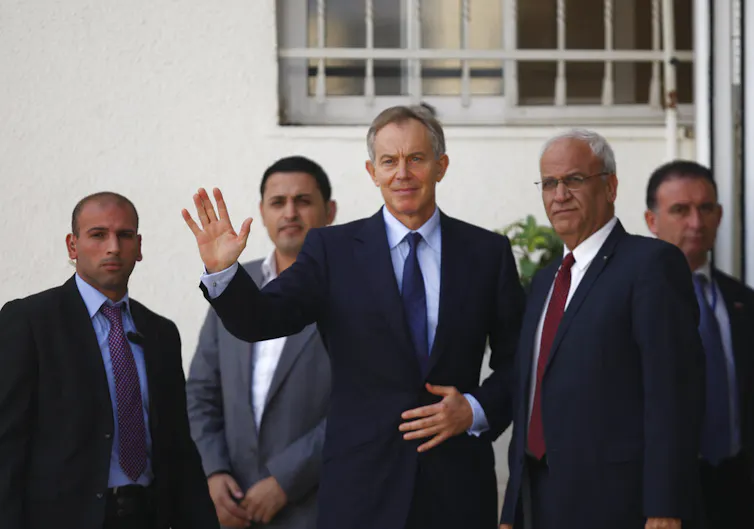 A man waves to a camera.