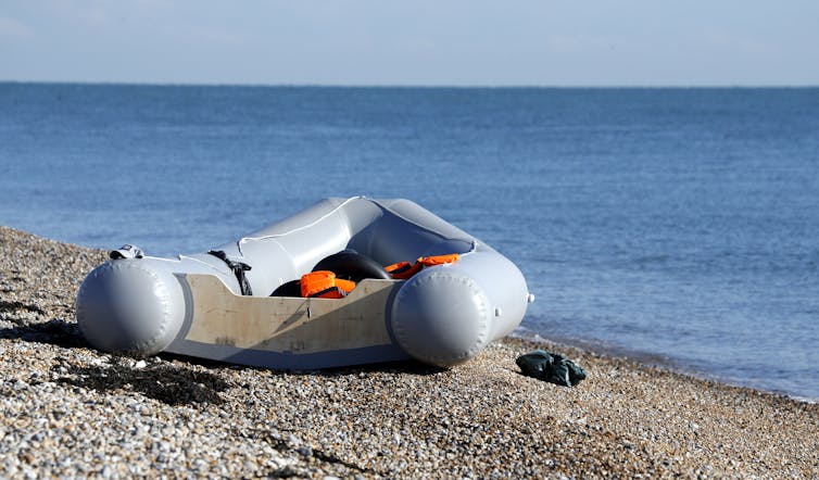 An empty dinghy sits on a beach in Kent