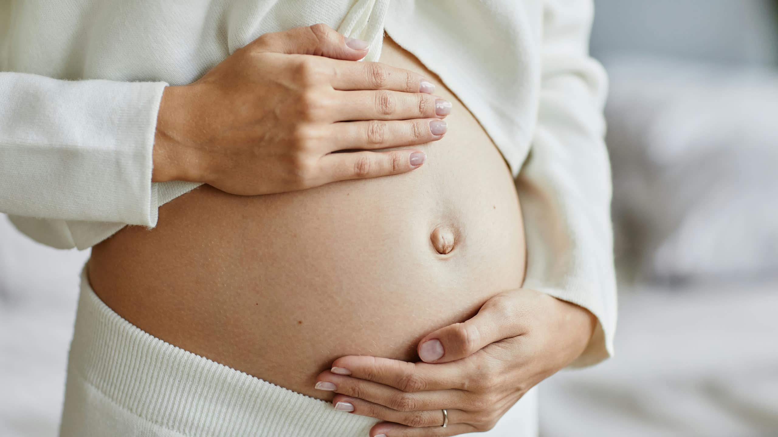 Une femme enceinte flatte son ventre