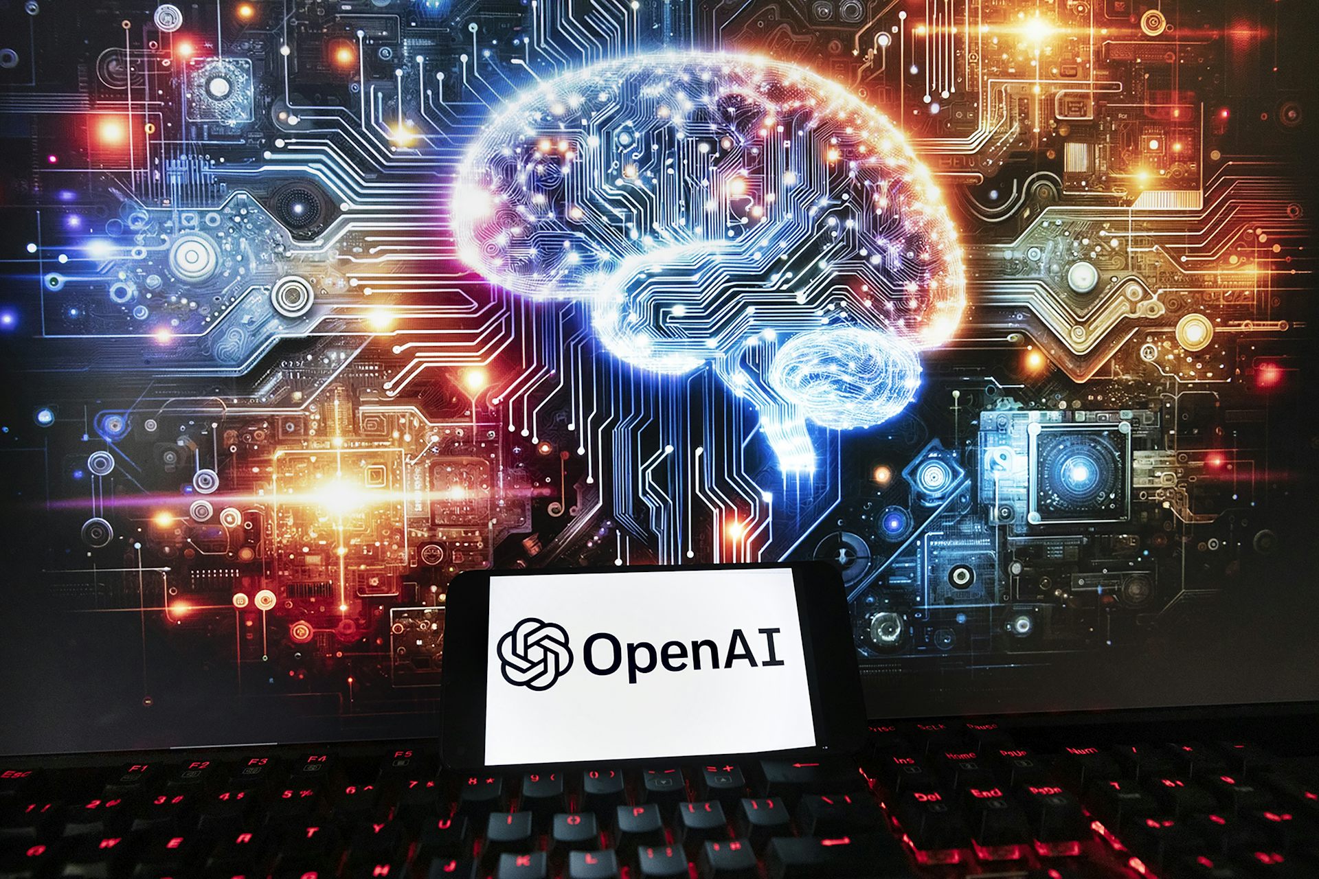 an image of a brain using the aesthetics of a chip behind a screen showing the openAI logo