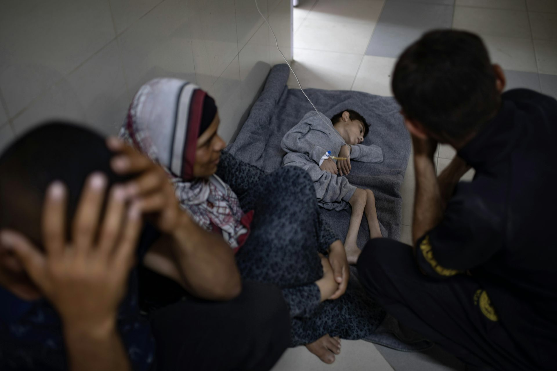 Palestinian child Younis Jumaa, suffering from malnutrition, lies on the floor over a blanket at Nasser Hospital in southern Gaza Strip in July 2024.