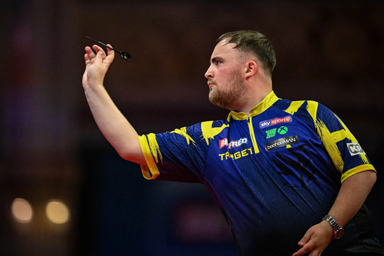 A photo of Luke Littler aiming to throw his dart.