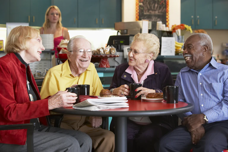 Older adults socialising in a cafe.