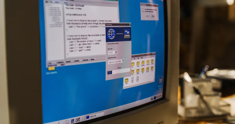 close-up of a 1990s desktop computer screen as it connects to internet.