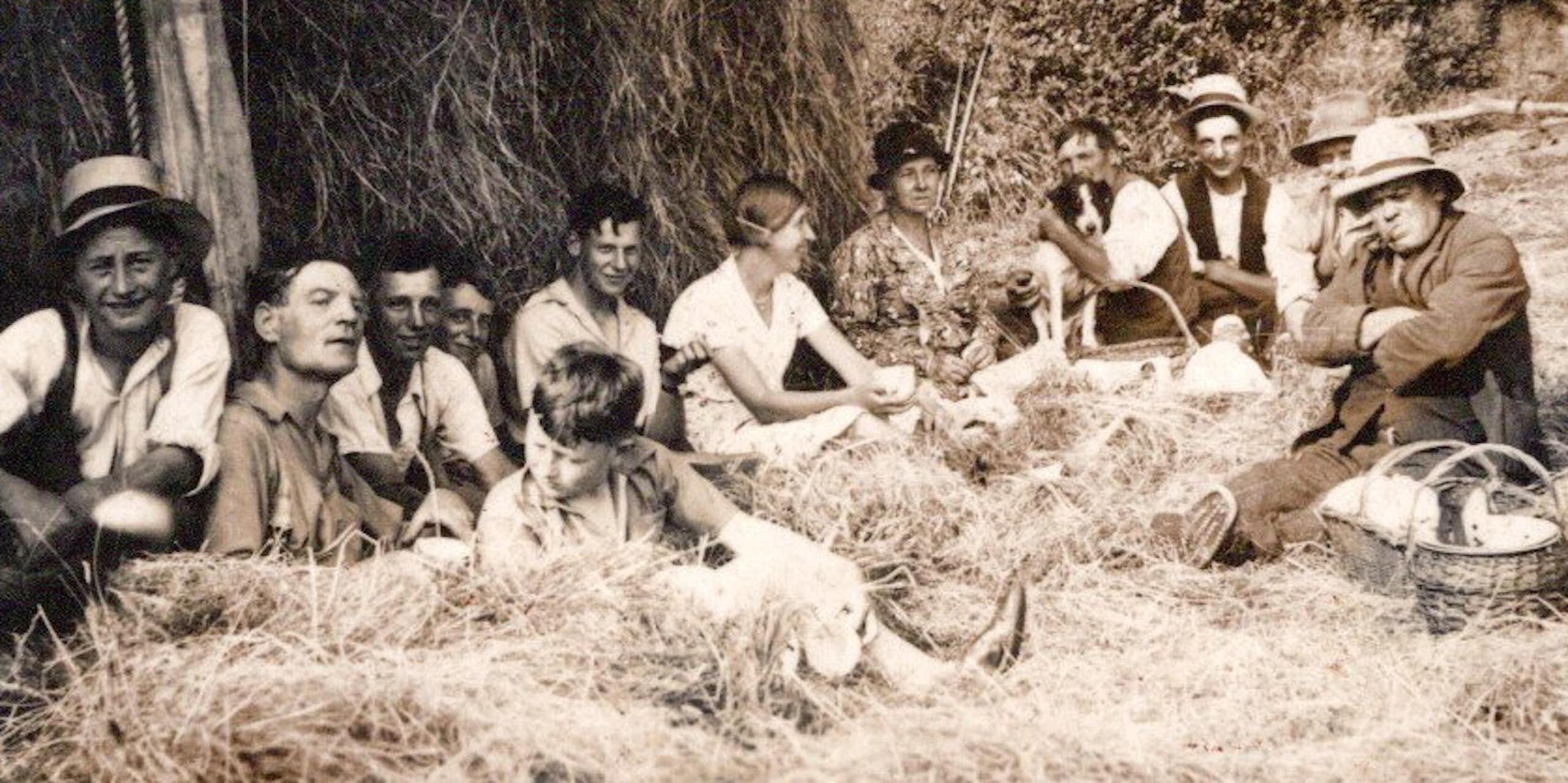 Farm labourers sat having what looks like a picnic