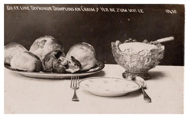 A black and white postcard showing Devonshire dumplings and cream.