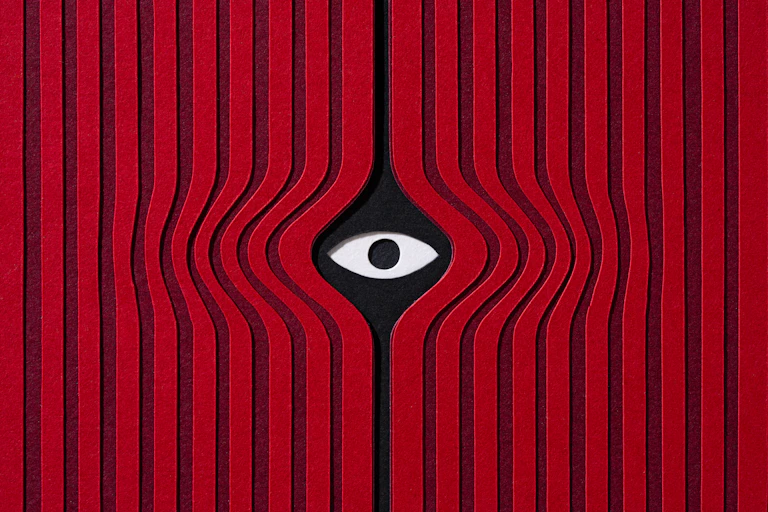 A graphic with red stripes and an eye peeking through in the middle