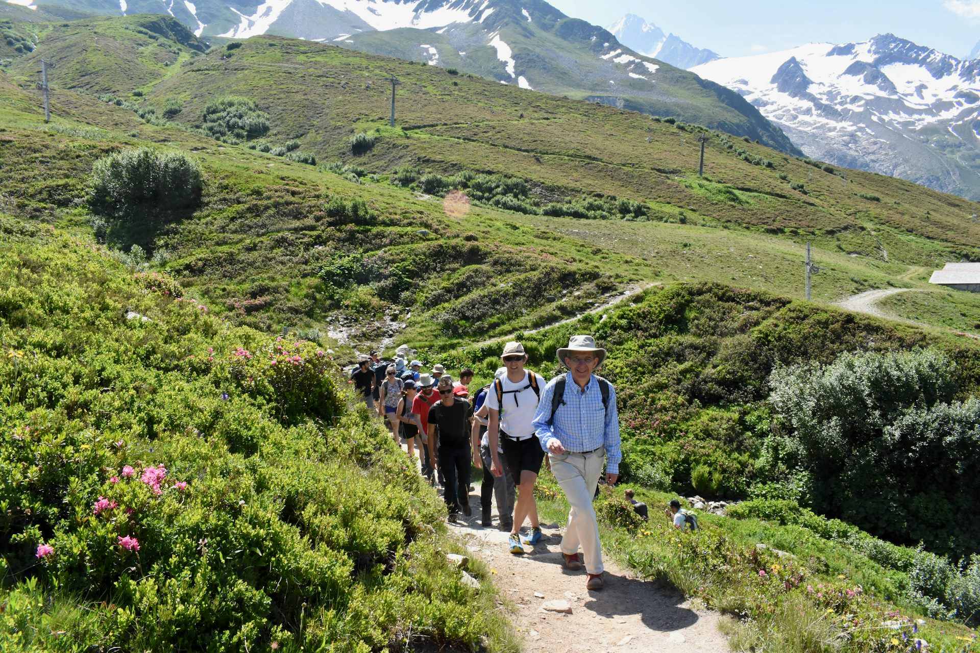 A group of people hiking across a mountain trail