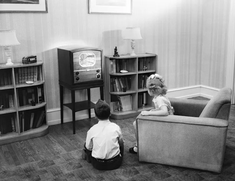 Two kids watching TV in the 1940s
