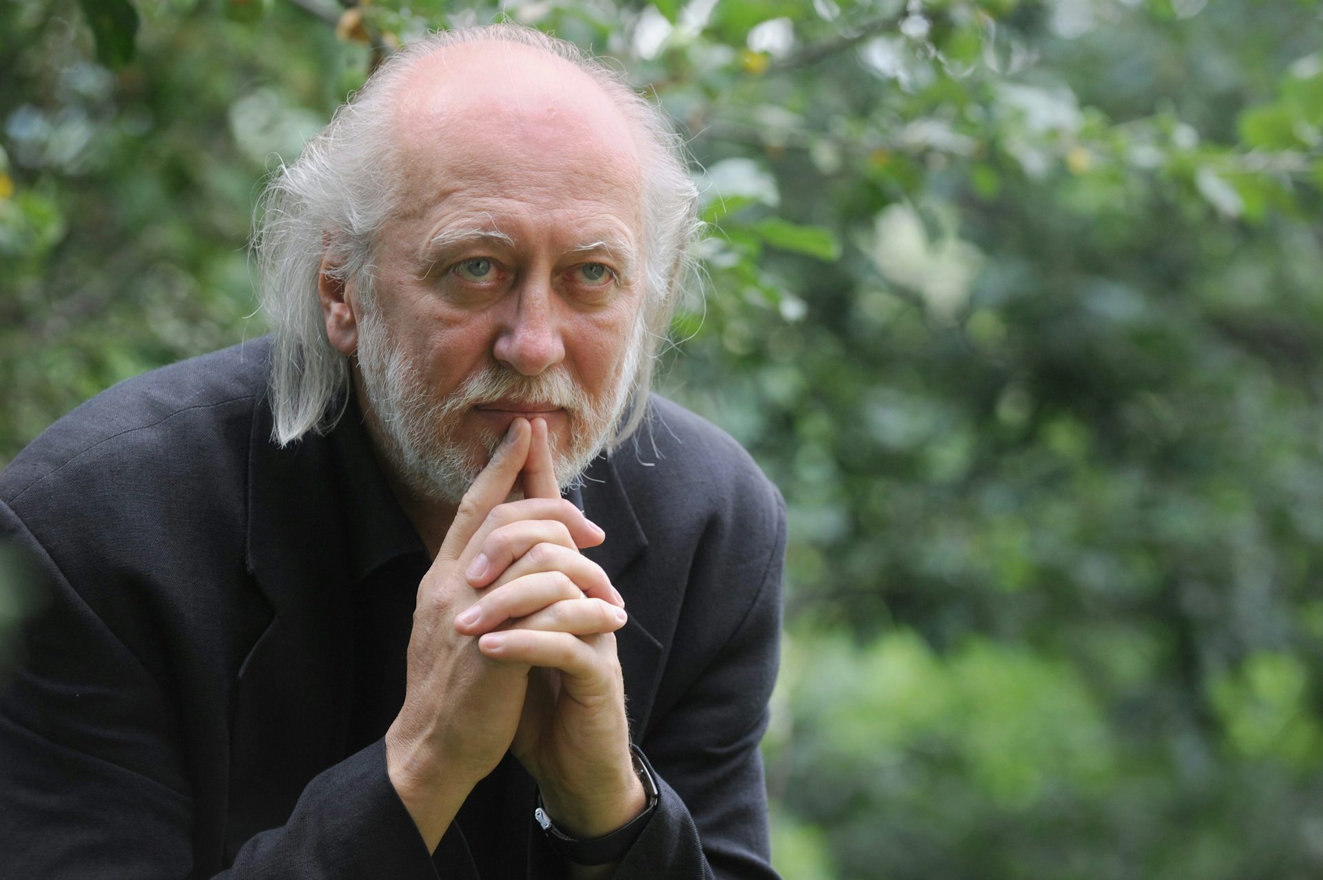 László Krasznahorkai sitting outside