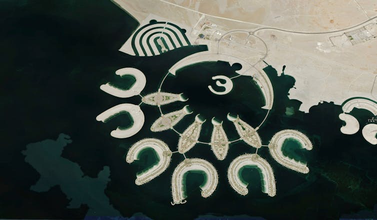 aerial shot of horseshoe shaped coastal islands in sea