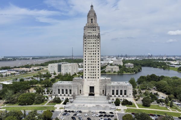 A large, white building with a tall tower in the middle.