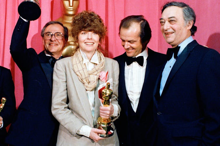 The four on a red carpet.