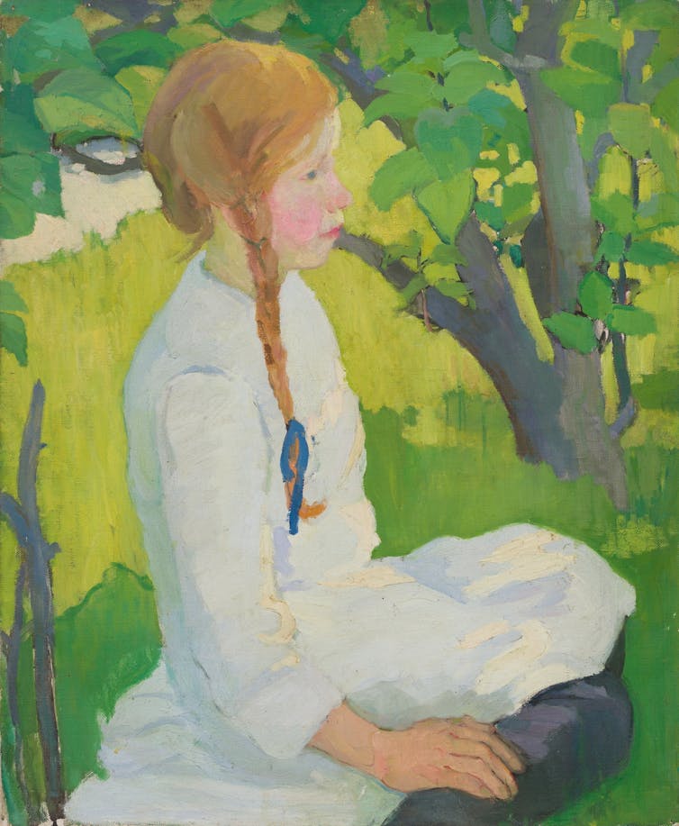 A girl sits outside.