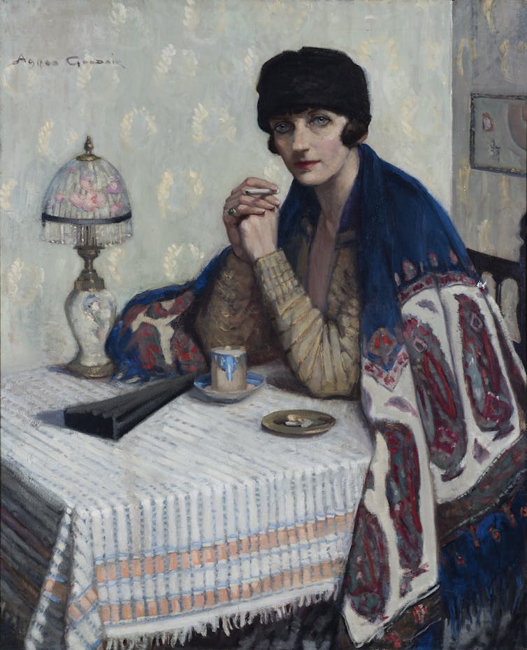 A woman at a cafe table.