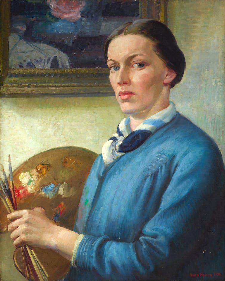 The artist holds a paint palette.