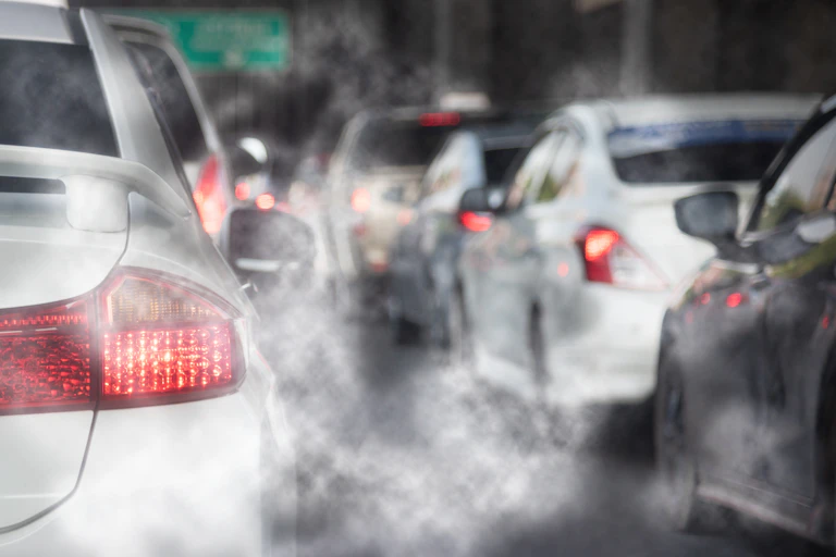 exhaust fumes from cars on road
