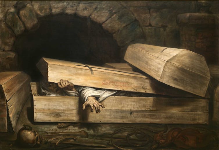A man crawls out of his coffin