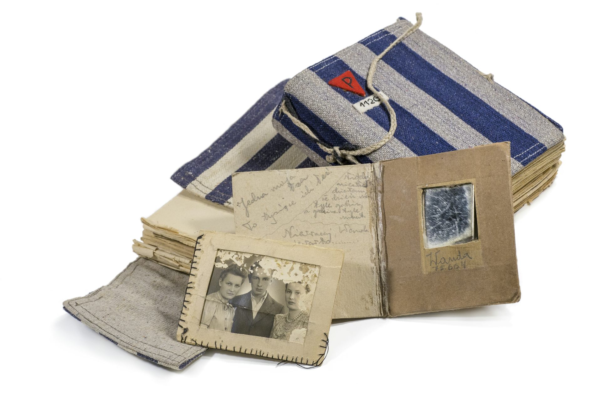 Note books containing poetry, a family photo and a handmade mirror, made by prisoners